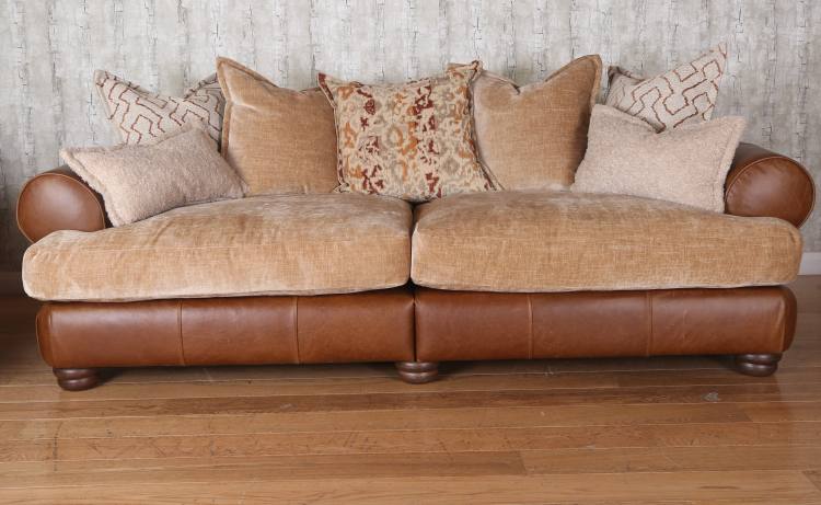 Grand pillow back sofa in Lazio brown leather / caramel rust fabric combination.